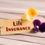 Life insurance tag with flower on a table