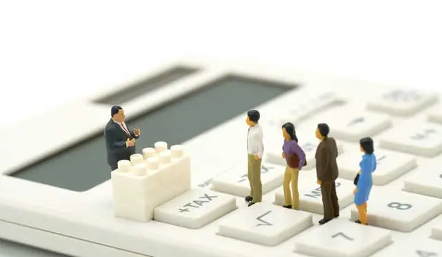 Small people on a calculator