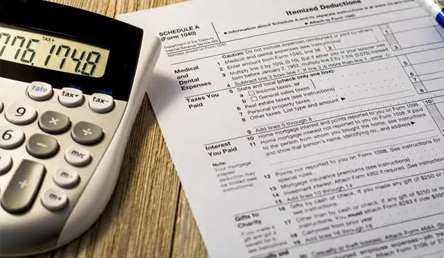 tax form with a calculator next to