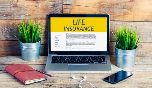 life insurance website on a mac with iphone next to