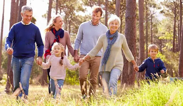 family walking in the woods